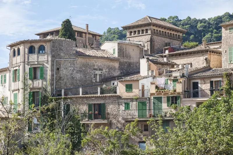 Mallorcan mountain village in front of forested mountains