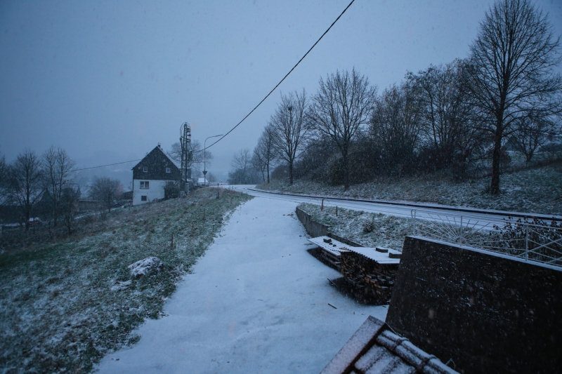 Snowy way through a winter hill landscape