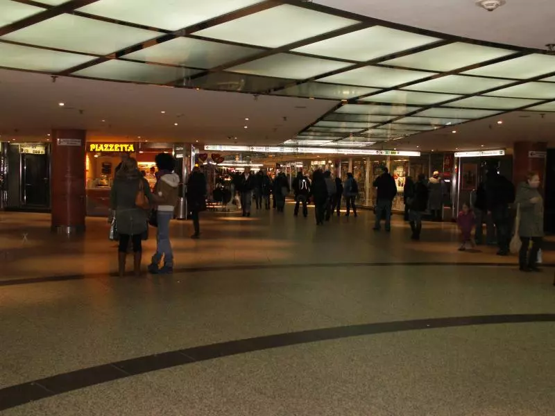 Travelers in a train station hall