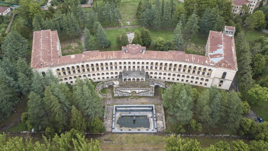 Historic sanatorium building surrounded by trees in Tskaltubo