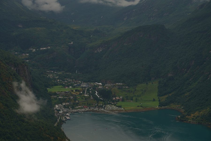 View across Geirangerfjord with steep wooded mountain slopes in Norway.