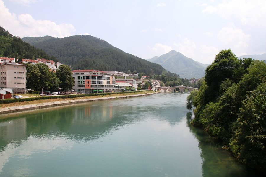 Neretva river in Konjic in front of a mountainous landscape
