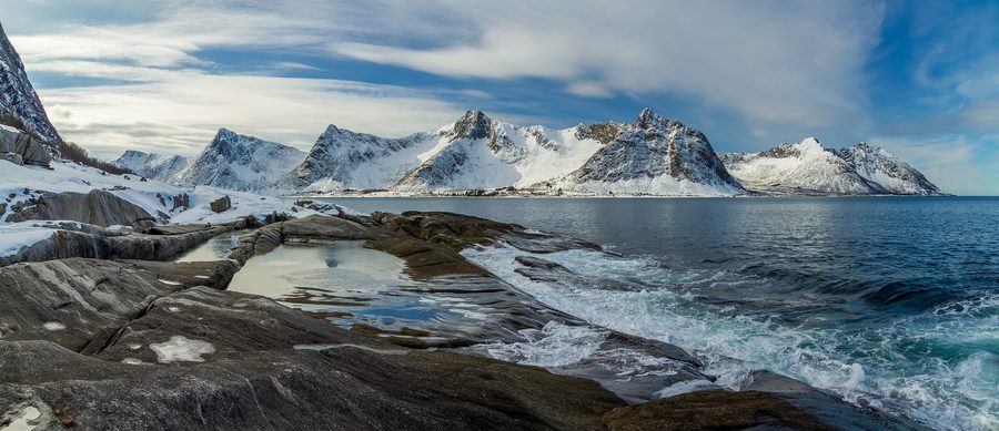 Rugged coastline at Tungeneset and Steinfjorden on Senja with mountains and fjord