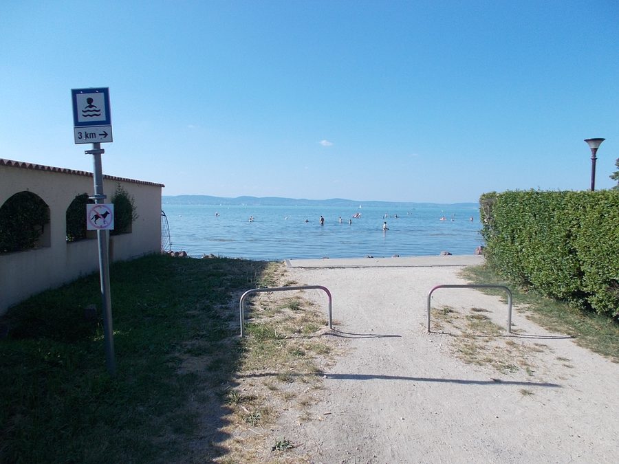 Beach at the western end of Kilátó Street in Zamárdi, Hungary, with people in Lake Balaton