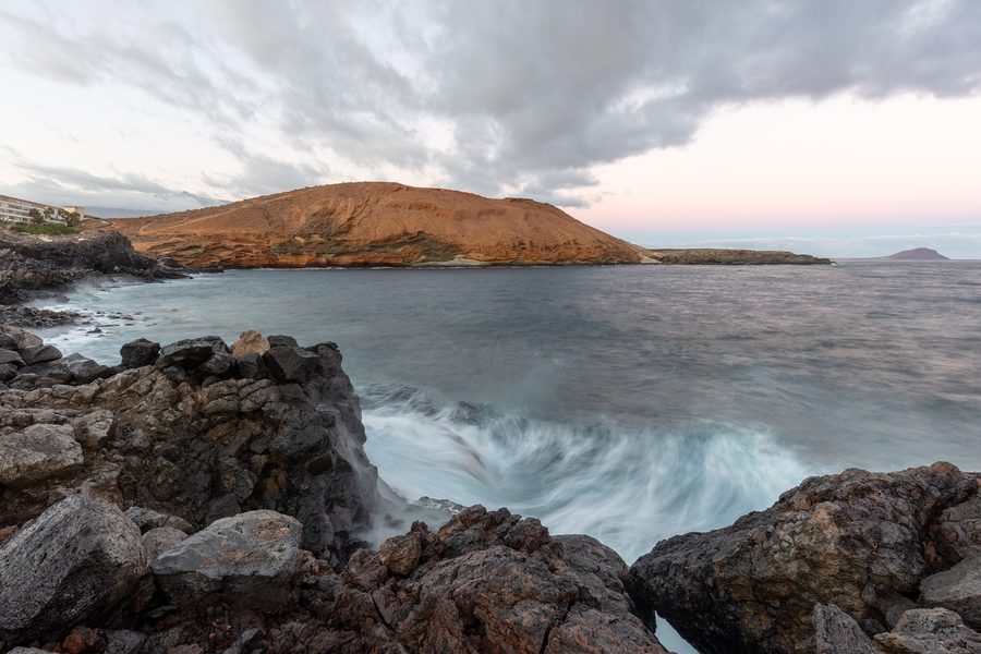 Montaña Amarilla with a yellow volcanic cone and rugged coastline near Arona on Tenerife