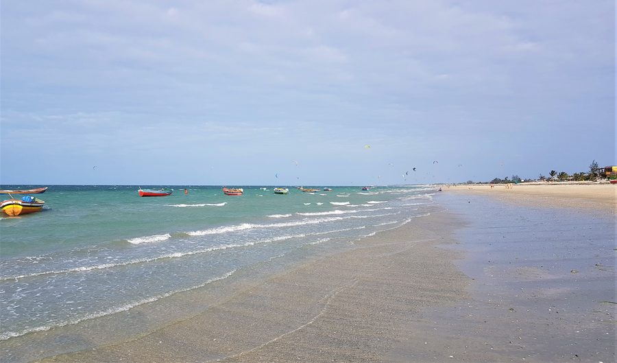 Sandy beach of Praia do Preá in Cruz in the Brazilian state of Ceará with boats and kites in the background