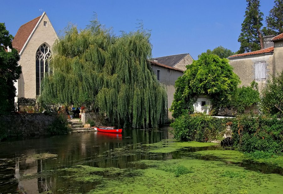 The Charente river before the former Convent of Cordeliers in Verteuil-sur-Charente, Charente, France