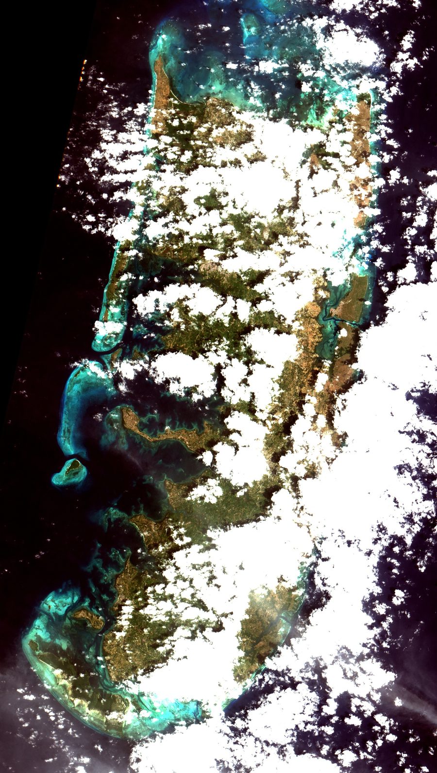 Aerial view of the south of Pemba Island in Tanzania, with mangroves, shallow waters, and the Indian Ocean.