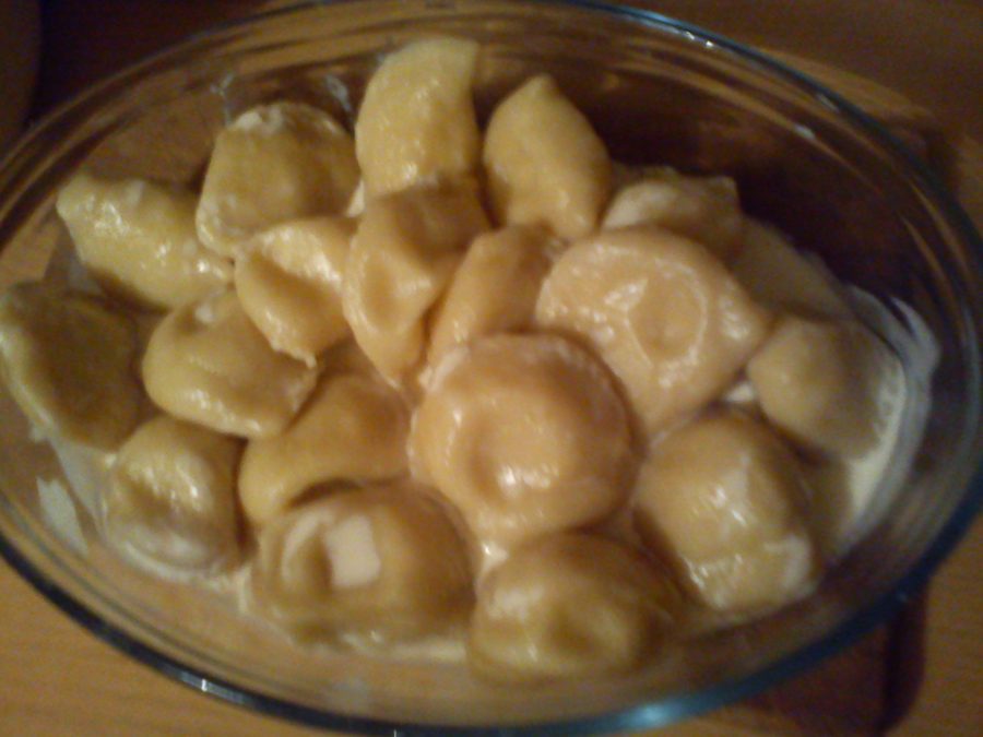 Pierogi ruskie with sour cream on a plate