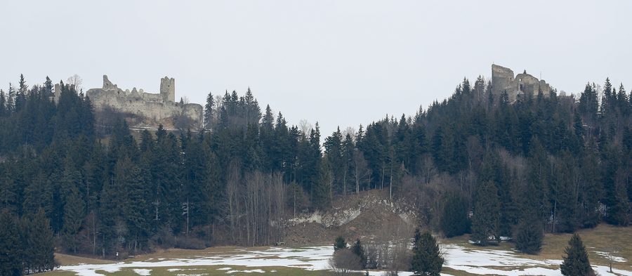 The opposing castle ruins of Eisenberg and Hohenfreyberg on wooded hills in the Ostallgäu