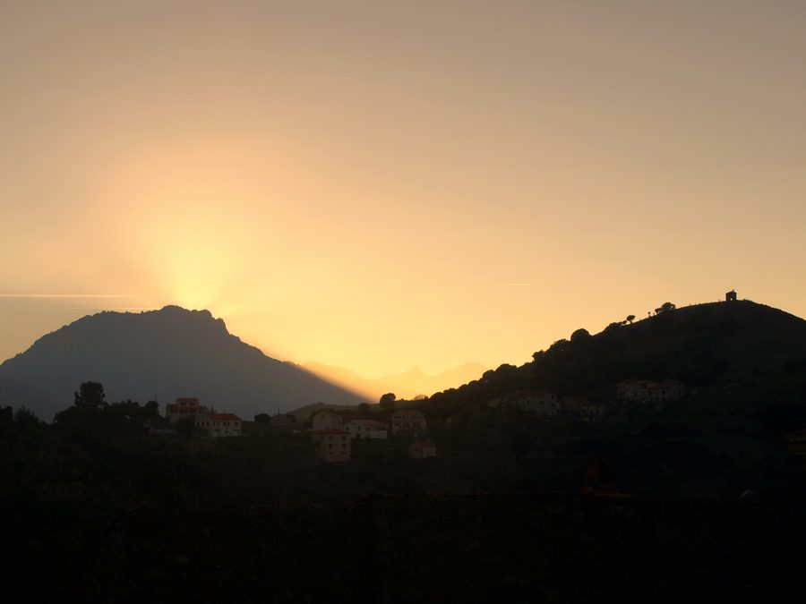 Sunset over Pedano near Pietralba with the ruins of the Saint-Michel chapel