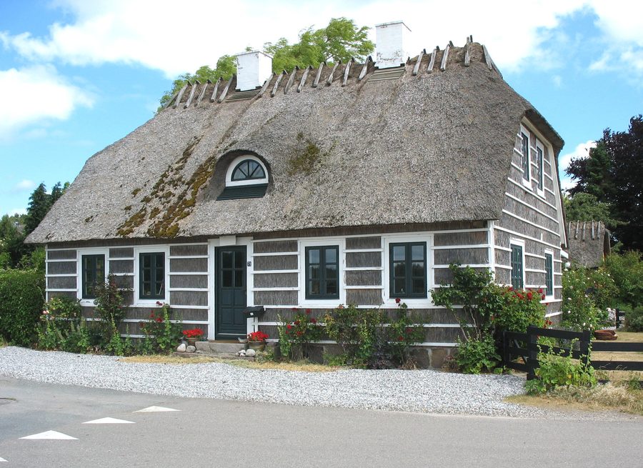 Characteristic historic house clad in straw in the fishing village of Hesnæs on Falster