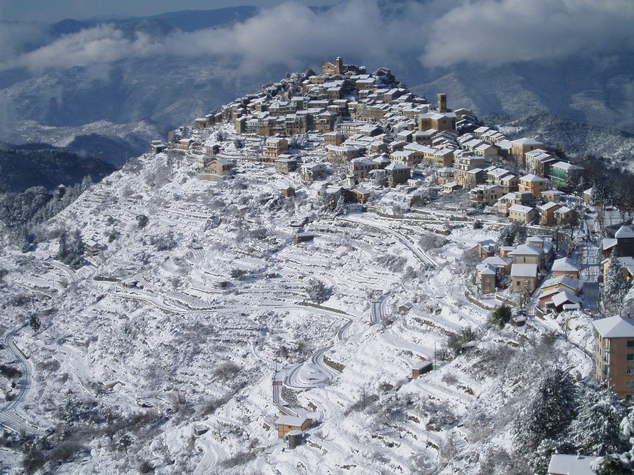 View of Bajardo in the Province of Imperia with snow-covered houses and slopes