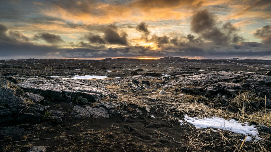 Sunrise over a rocky coastal landscape on the southern peninsula of Iceland.