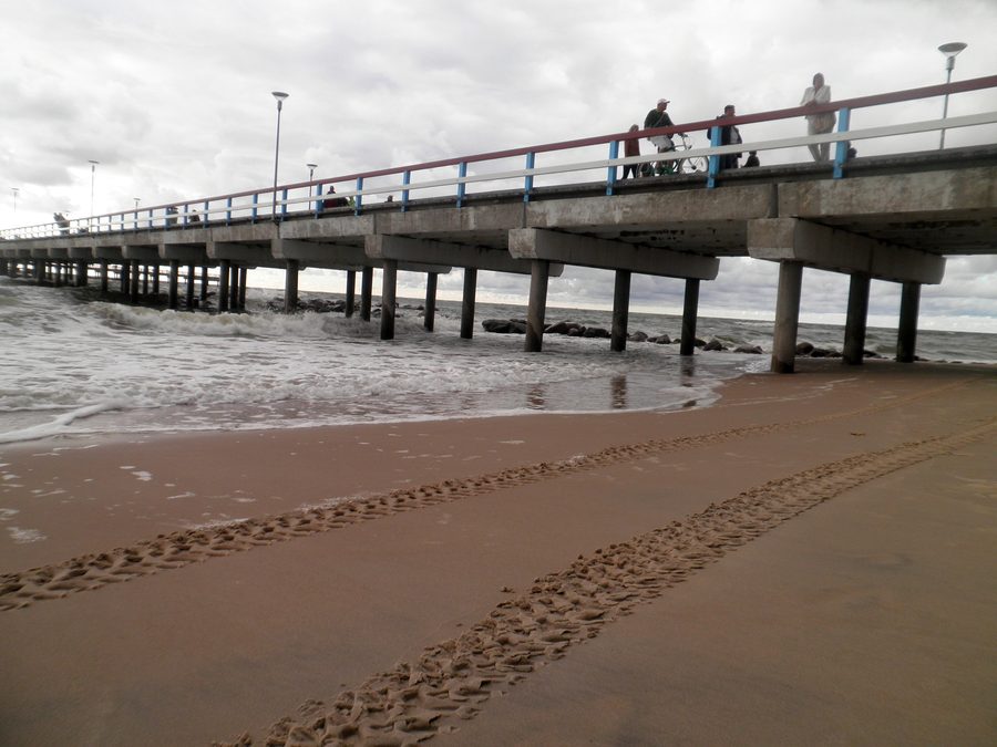 Palanga Pier on a cloudy day beside the sandy Baltic Sea beach