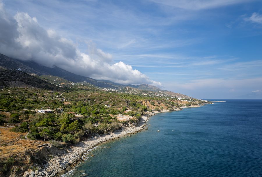 Aerial view of the mountainous southern coast of Ikaria with Agios Kirykos in the distance