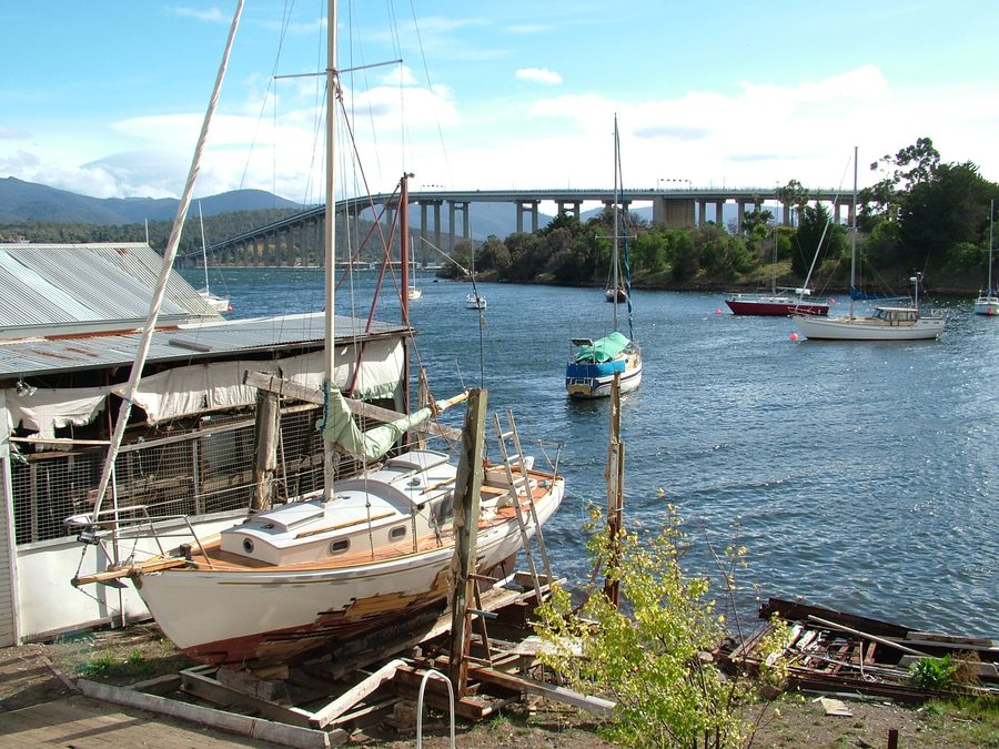 View over Montagu Bay in Tasmania with a yacht on dry dock and the Tasman Bridge in the background