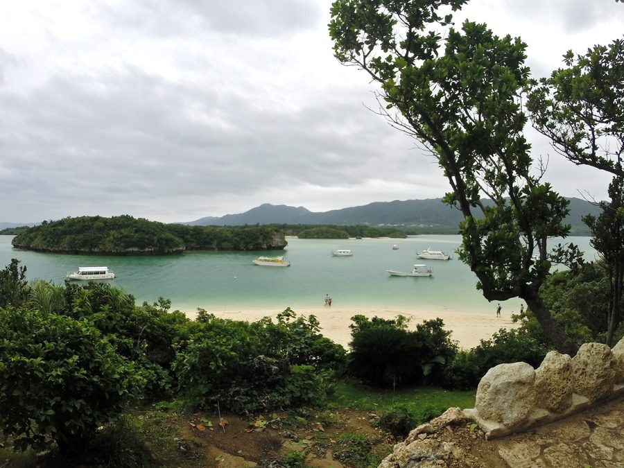 Kabira Bay on Ishigaki with a bright coastal strip, blue water, and green island landscape