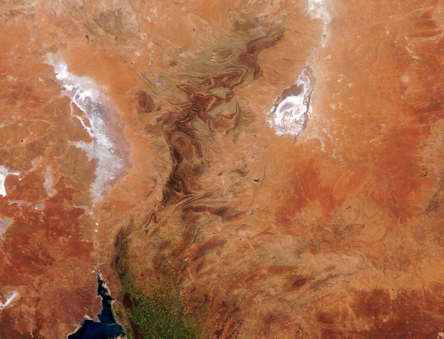 Satellite image of South Australia with dry outback, red landscapes, mountain ranges, and salt lakes