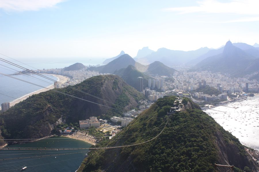 Panoramic view of Rio de Janeiro with Copacabana Beach, Morro da Urca, and Christ the Redeemer seen from Sugarloaf Mountain.