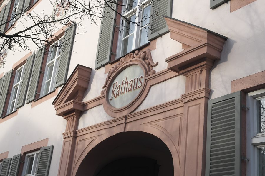 Entrance of Erding's Grafenstock town hall with stepped gable and stucco cartouche