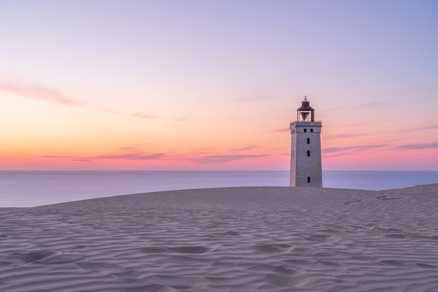 Rubjerg Knude Lighthouse standing on high sand dunes near the North Sea coast.