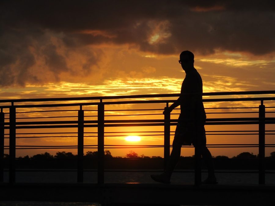 Person on the Guaíba waterfront in Porto Alegre at sunset