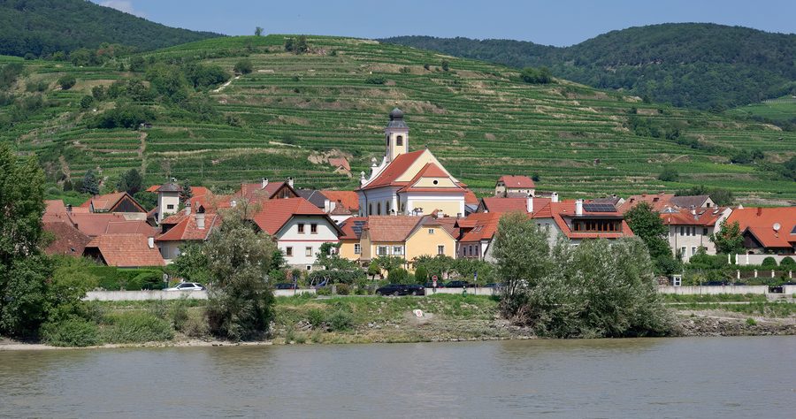 View from the Danube bank toward Wösendorf in the Wachau with the parish church and vineyards in the background