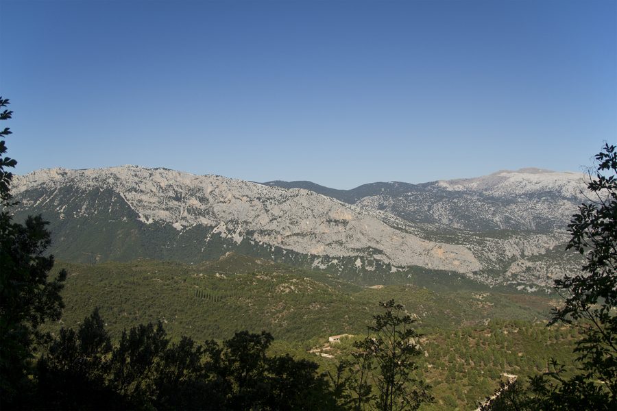 Panoramic view of the Supramonte landscape near Urzulei, with limestone formations and Mediterranean vegetation
