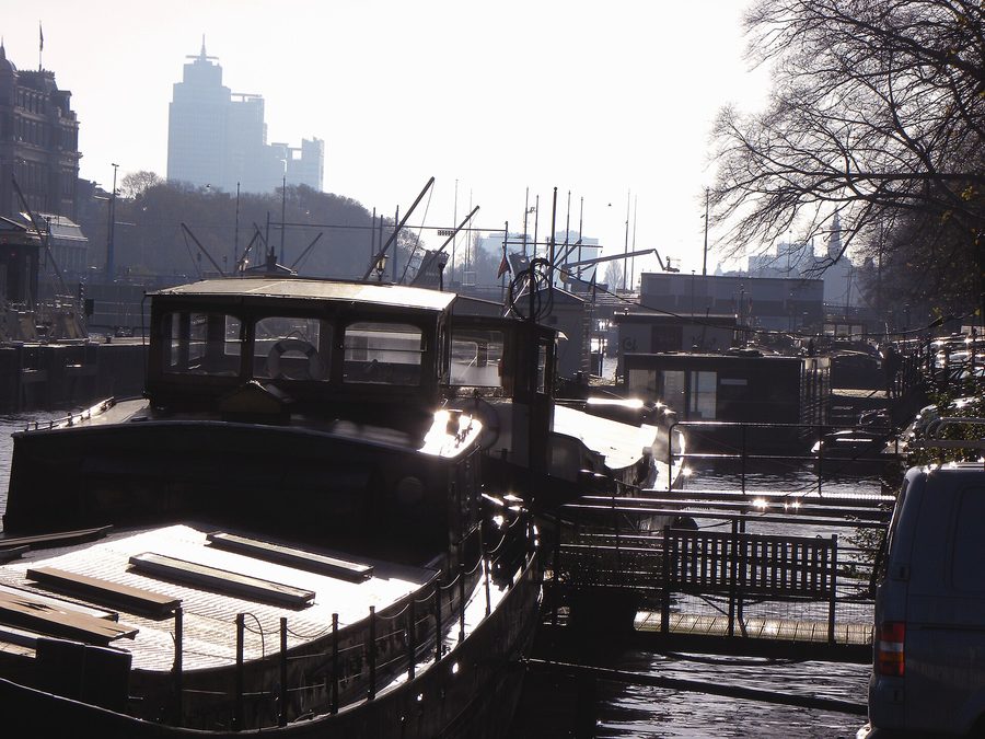 Houseboats lined up along a canal in Amsterdam