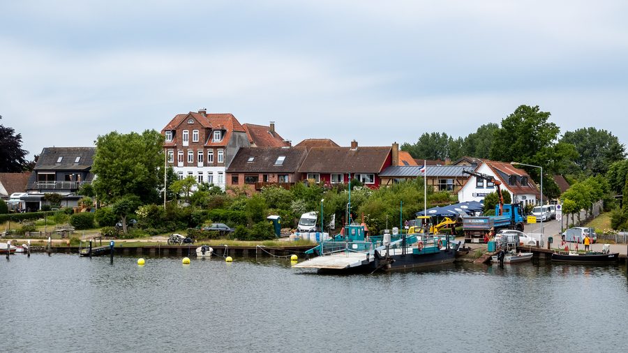 Ferry and ferry jetty in Arnis with row of houses