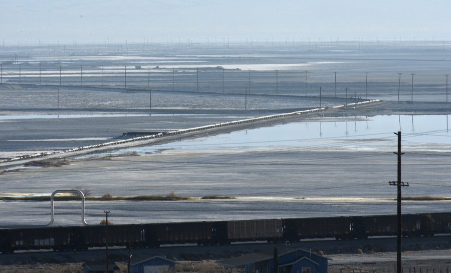View of Searles Dry Lake in Trona, California, with hills and a train in the foreground
