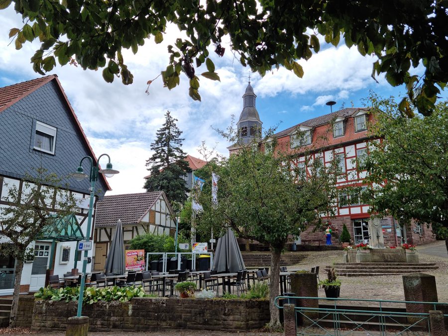 Main Street with church, church tower and town hall in Bad Zwesten