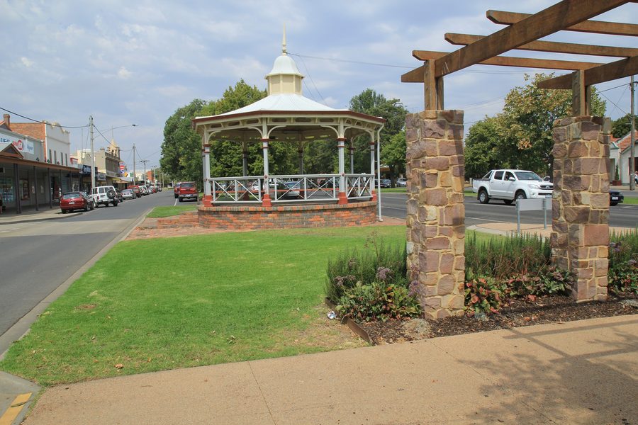 Street view of Maffra with historic buildings and a green streetscape