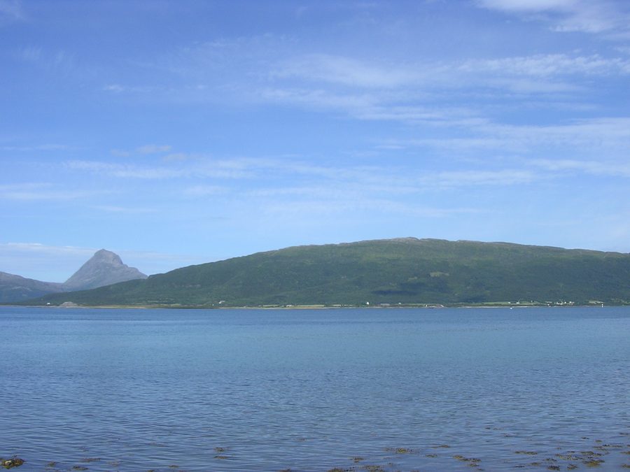 Handnesøya in the municipality of Nesna, seen from Nesna, with the mountain Tomskjeveln on the island of Tomma in the background.
