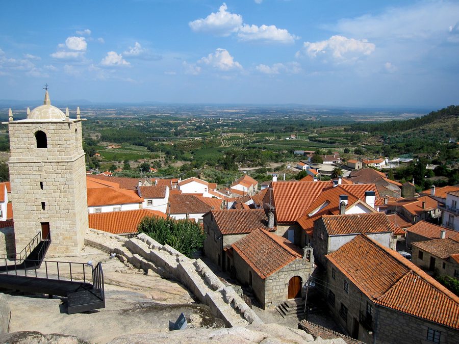 View of Castelo Novo village from the castle, showing historic buildings and surrounding landscape