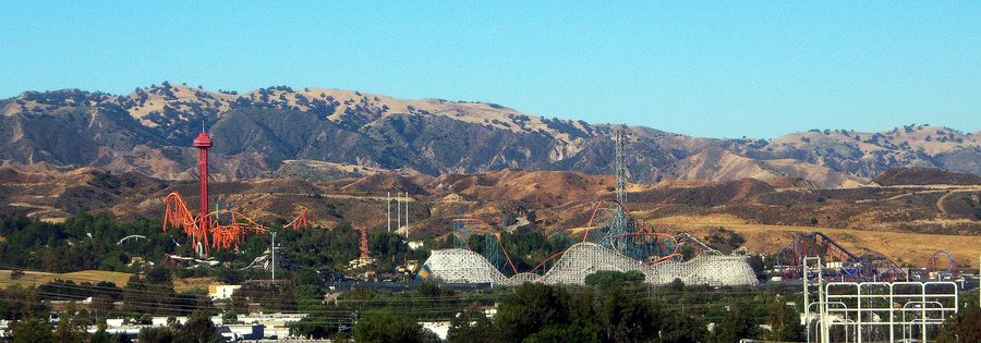 Overview of Six Flags Magic Mountain with roller coasters and surrounding hills