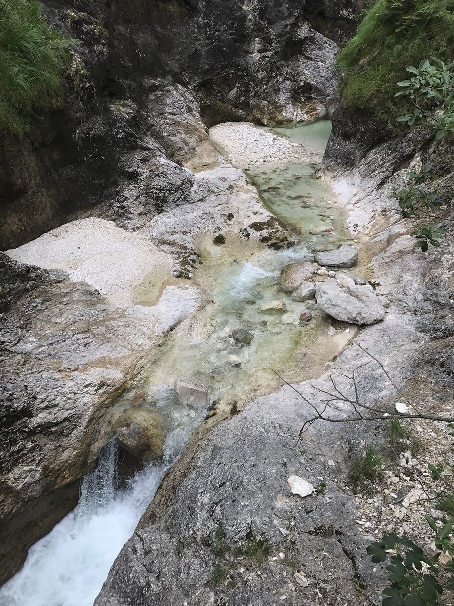 Almbachklamm near Marktschellenberg with rock walls, waterfall, and wooden footbridge