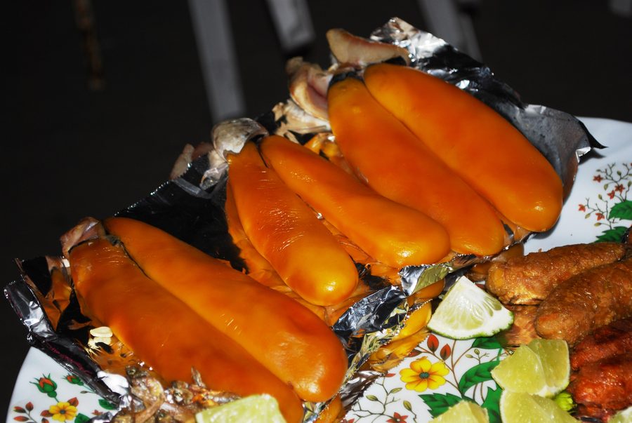 Tubes filled with fish roe for sale by a roaming vendor at Puerto Arista beach