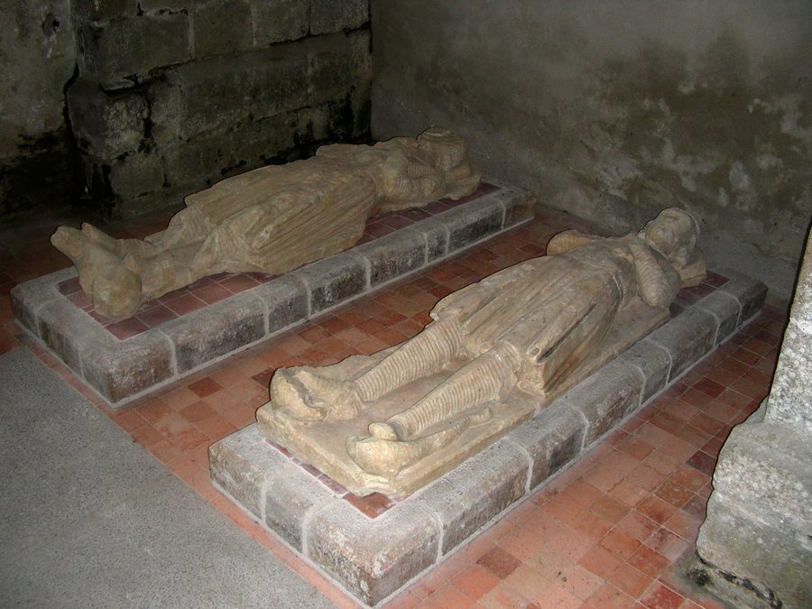 Interior of the Trinity Abbey church at La Lucerne-d'Outremer, with recumbent effigies.