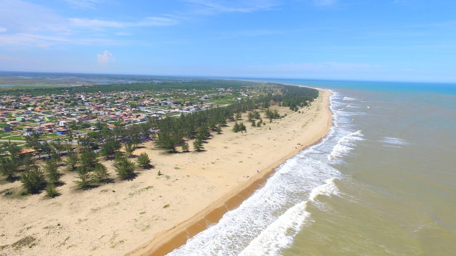 Beach of Farol de São Thomé with the historic lighthouse in Campos dos Goytacazes