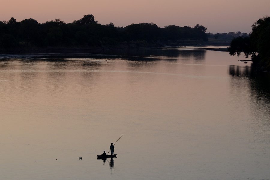 Fishermen by the water