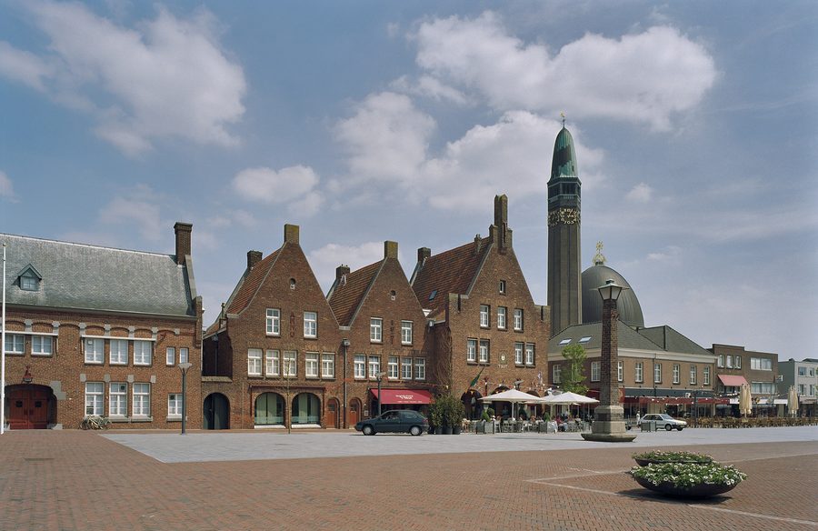 Historic town hall complex at Raadhuisplein in Waalwijk with Sint Jan de Doperkerk in the background