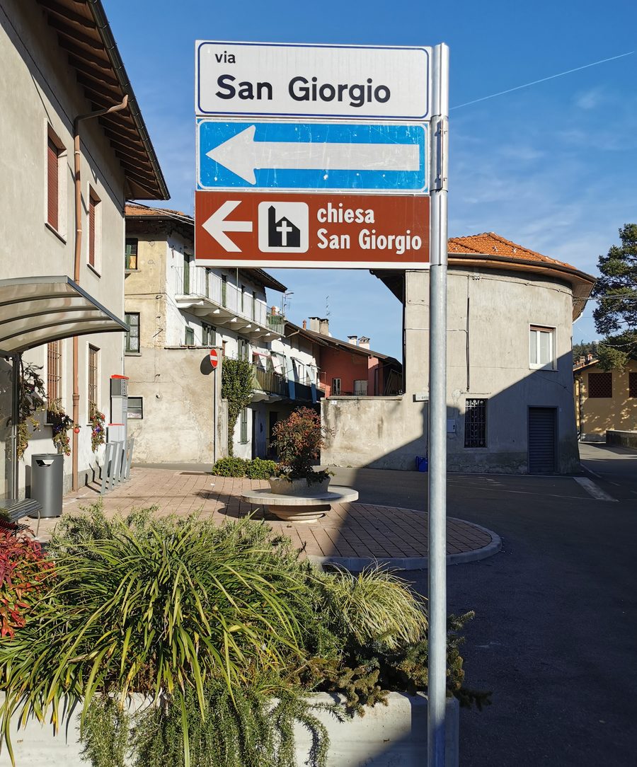 Tourist and road signs in Corgeno, at the southern end of Via San Giorgio