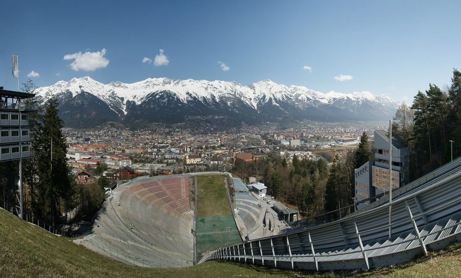 Panoramic view of Innsbruck with the Nordkette and Tyrolean Alps behind the city.