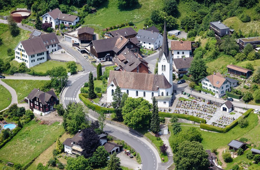 Aerial view of the parish church of St. Agnes and the cemetery in Klaus in Vorarlberg