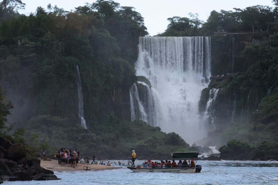 Wide waterfall of the Iguazú Falls in densely wooded landscape
