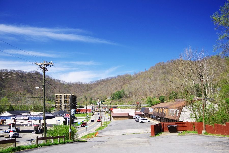 Row of shops on Main Street in Chapmanville, West Virginia, with US 119 in the background
