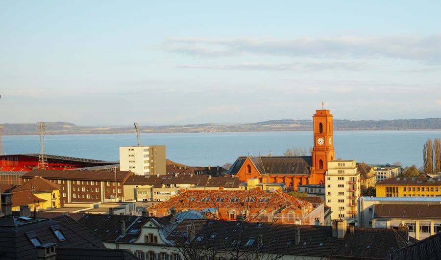 Part of Neuchâtel with the Church of Notre-Dame-de-l’Assomption and Lake Neuchâtel in the evening light