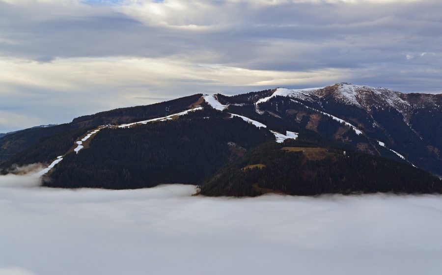 Schmittenhöhe above Zell am See with fog covering the basin, lake and town